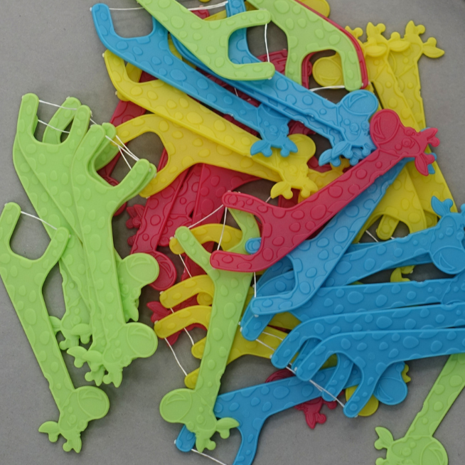 Colorful plastic toothpicks on a gray surface